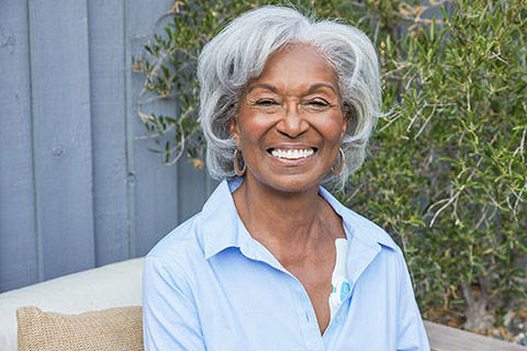 Female sitting outside smiling