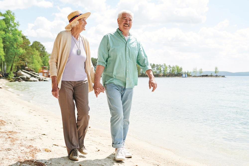 Couple walking lakeside with Nortek device