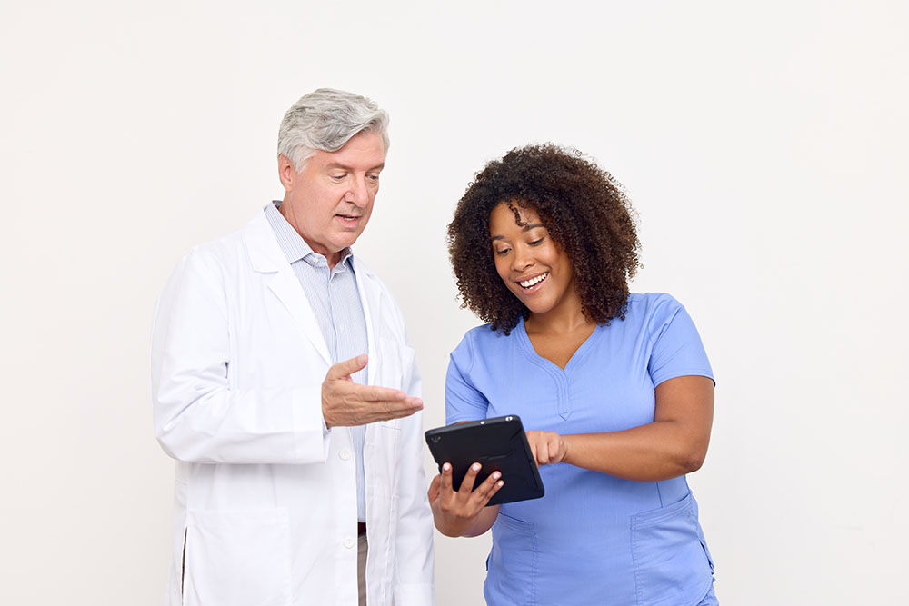 Physician reviewing electronic order with nurse