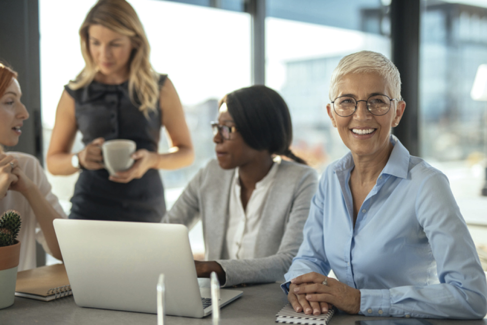 Corporate OlderWomanwithGlass 3womenoncomputercoffee 1000