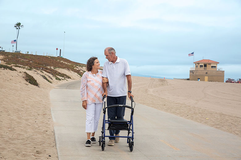 DME WhiteCouple WalkingNearBeach DriveRollator