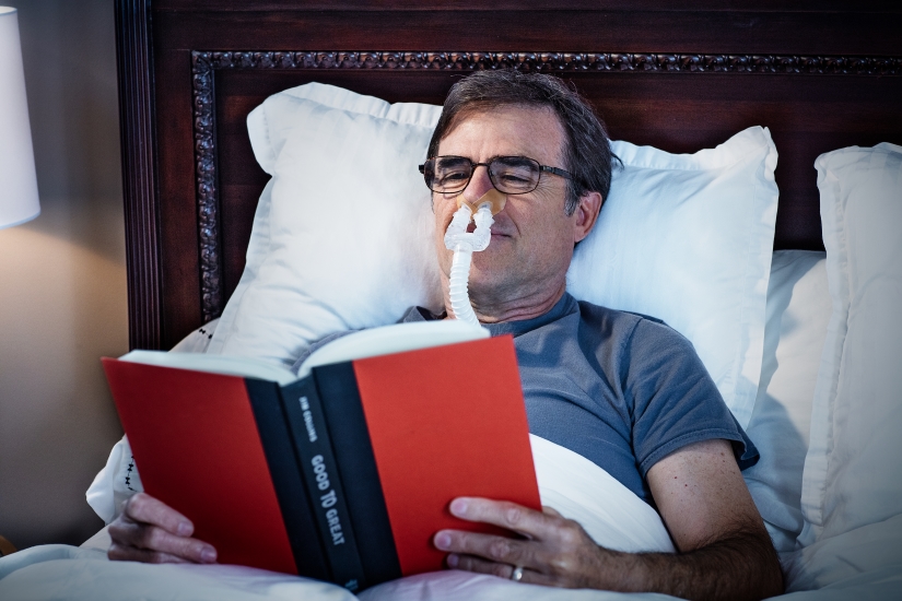 DreamPort man reading in bed