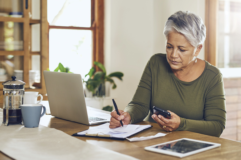 Female adult looking at paper bill
