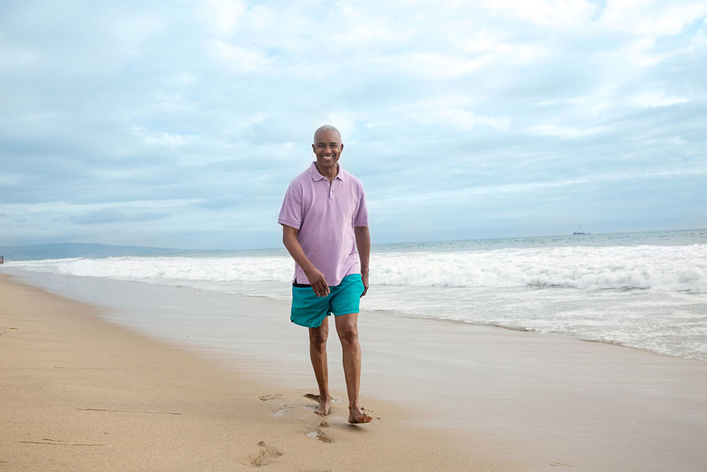 Lifestyle BlackMale BeachWalkingAlongSmilingatCamera