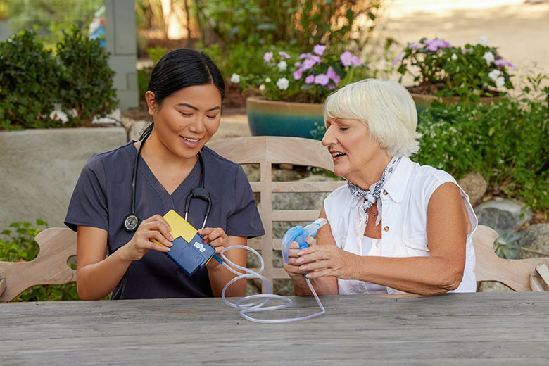 NebulizerAsianClinicianWhiteFemaleSittingOutsidePortableNebulizerPariTrekWithBatteryCharger4745LCS14