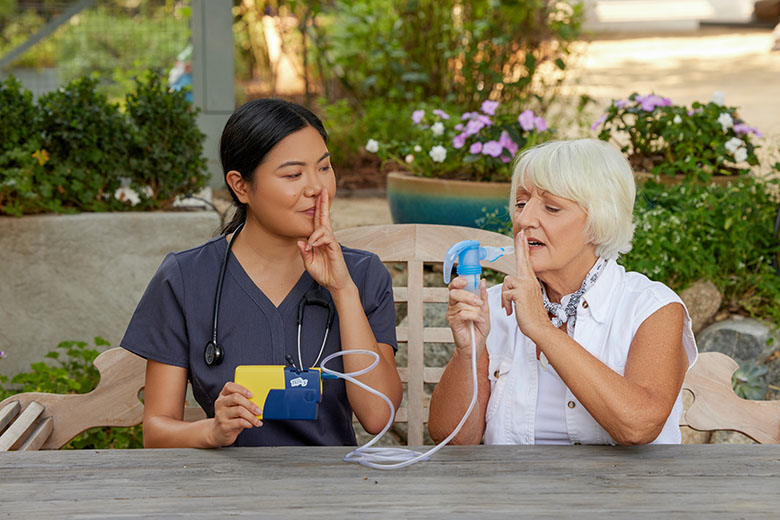 NebulizerAsianClinicianWhiteFemaleSittingOutsidePortableNebulizerPariTrekWithBatteryCharger4745LCS3