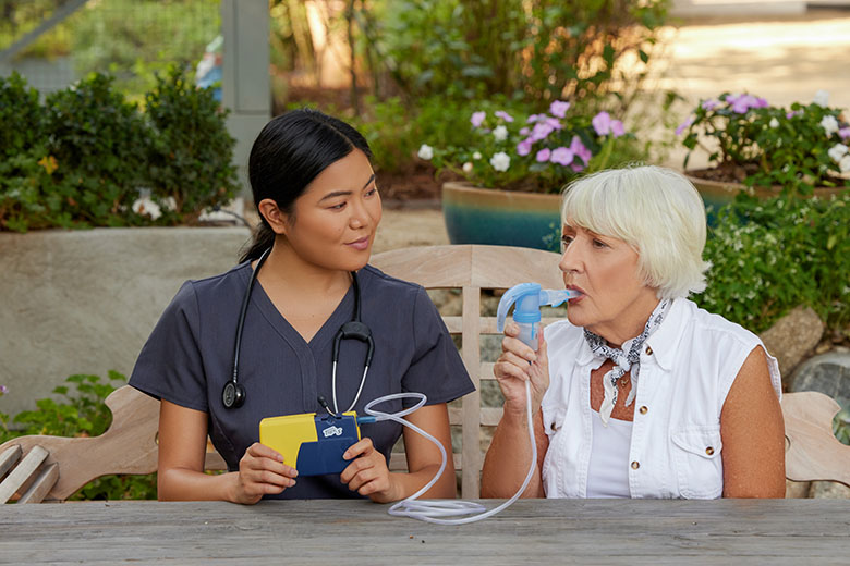 NebulizerAsianClinicianWhiteFemaleSittingOutsidePortableNebulizerPariTrekWithBatteryCharger4745LCS6
