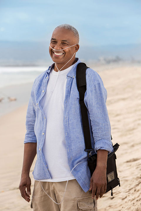 Oxygen BlackMalePatient POC StandingOnBeachSmiling ActiveLifestyle