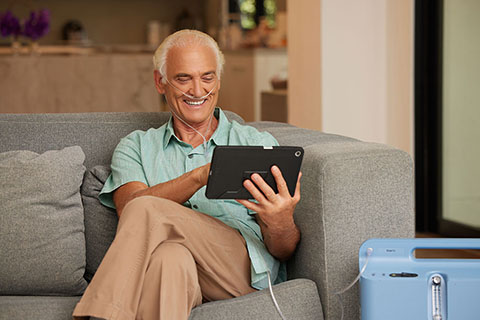 Oxygen WhiteMale sittingOnCouchReadingTablet