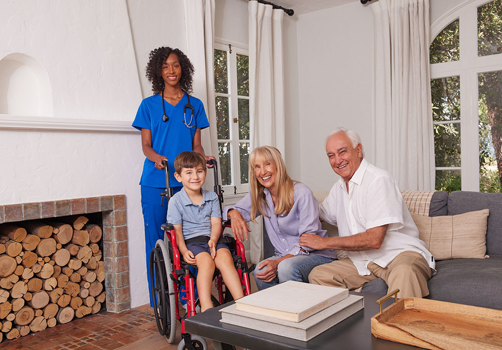 Pediatric Black Female Clinician White Family Young Boy Pediatric Wheelchair Living Room