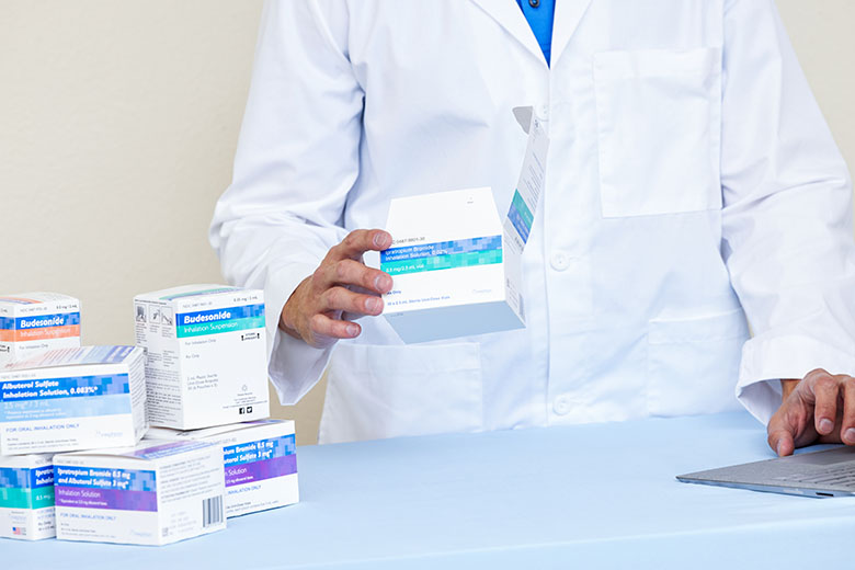 PharmacyWhiteMalePharmacistLaptopHoldingUnitDoseMedicationsAlbuterolSulfateIpratropiumBromideIpratro