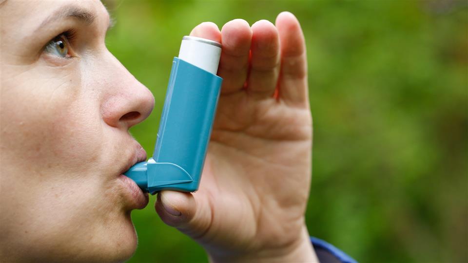 person using inhaler