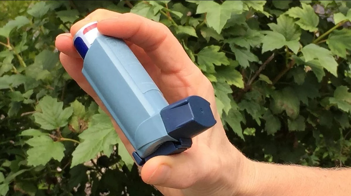 person holding inhaler