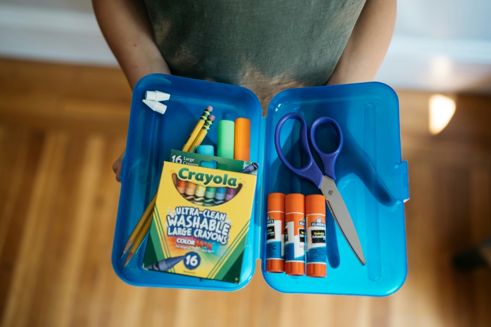 school supplies including crayons, glue sticks, scissors and more