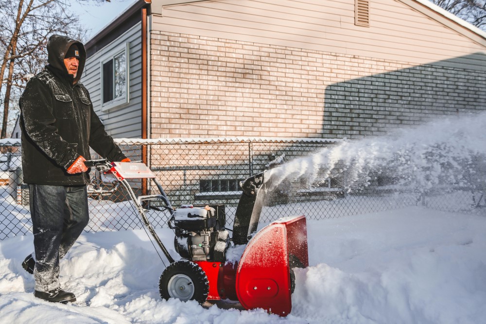 person using snow blower
