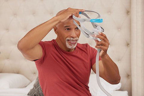 Sleep Apnea BlackMaleOlderPatient Smiling HoldingResMed AirFitF30PAPmask