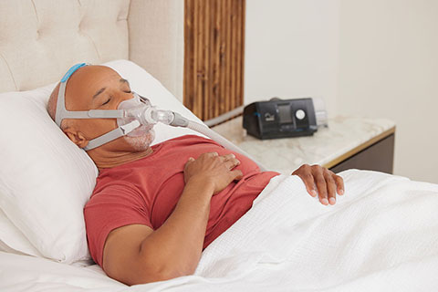 Sleep Apnea BlackMaleOlderPatient Smiling WearingResMedAirFitF30PAPmask ResMedAirSense10PAP Sleeping