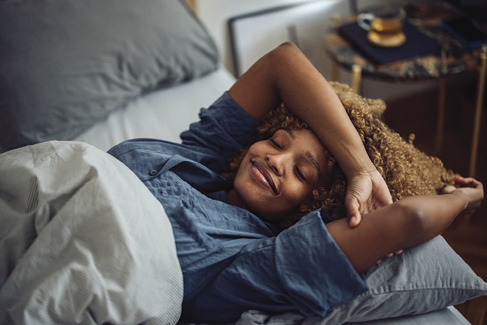 Female laying in bed, feeling rested