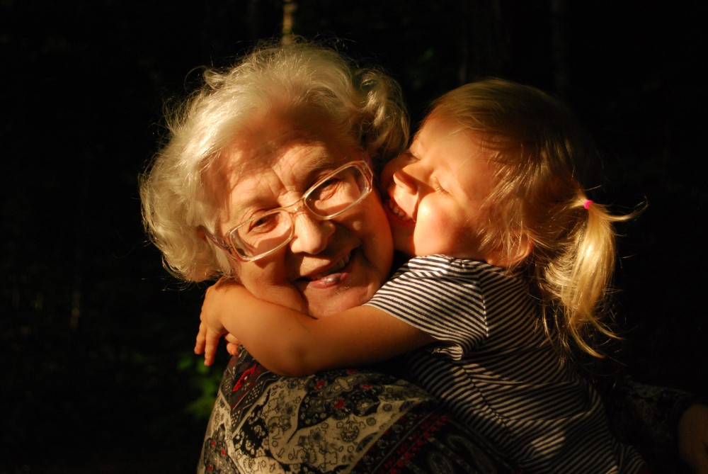 grandmother and granddaughter embraced in a hug