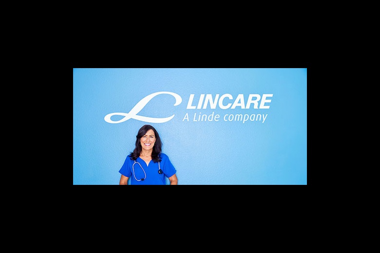 Lincare employee in front of a Lincare sign