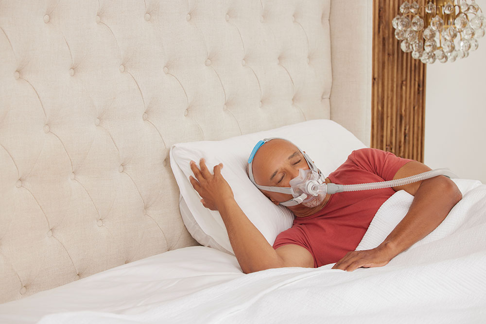 Sleep Apnea Black Male Older Patient Wearing ResMed AirFitF30PAPmask Sleeping