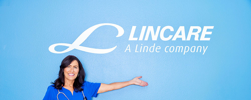 Center Female Standing Arm Extended Under Lincare Logo